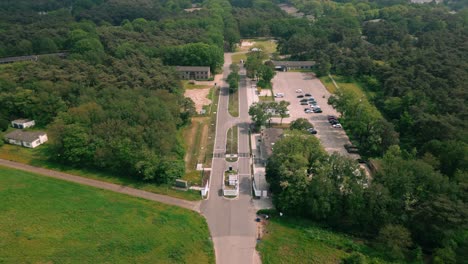 Aerial-footage-of-the-entrance-to-Budel-asylum-refugee-camp,-showing-the-gate,-surrounding-fences,-and-nearby-buildings