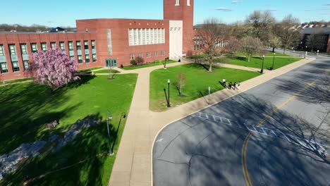 High-school-students-walking-past-front-of-American-city-public-school