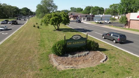 Welcome-to-Dearborn,-Michigan-sign-from-above-with-traffic-and-stable-video