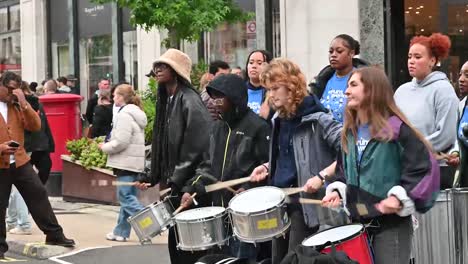 Banging-the-drums-in-Regents-Street,-London,-United-Kingdom