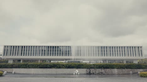 Toddler-Biking-In-Front-Of-Prayer-Fountain-At-Peace-Memorial-Park-In-Hiroshima,-Japan