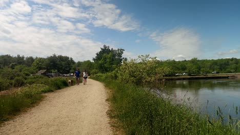 Man-rides-bike-along-the-Eastern-Trail-Scarborough,-Maine