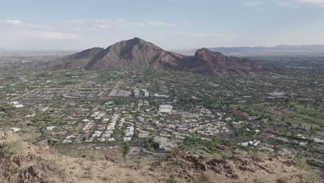 Drone-view-of-Paradis-Valley-with-wealthy-houses-and-camelback-mountains-at-background-in-Arizona,-USA