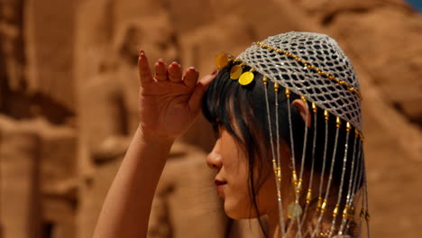 Woman-Wearing-Traditional-Jewelry-in-Front-of-Abu-Simbel-Temple,-Focus-pull