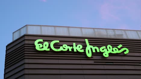 The-logo-sign-of-Spain's-largest-department-store-company,-El-Corte-Inglés,-is-seen-on-its-building-during-nighttime-in-Madrid,-Spain