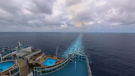 Looking-out-the-back-of-a-cruise-ship-and-viewing-the-activities-and-the-wake-of-the-ship