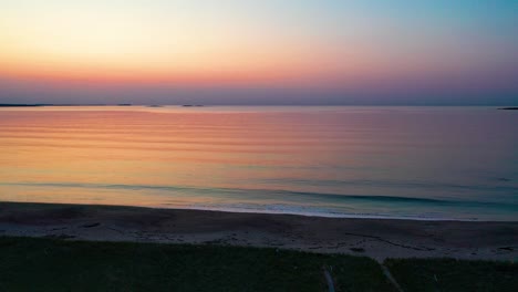 Wooden-Walking-Path-Leads-to-Colorful-Beach-Sunrise-With-Ocean-Waves