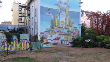 Incredible-graffiti-street-art-of-a-Ukrainian-girl-on-a-house-in-Andriyivskyy-Descent-in-Kyiv-old-town-Ukraine,-4K-shot