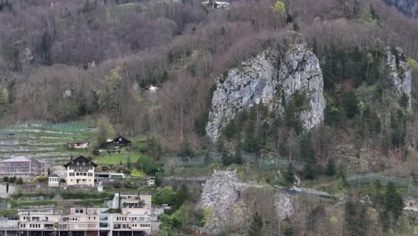 Drone-clip-showing-helicopter-flying-to-drop-package-at-remote-Alpine-village