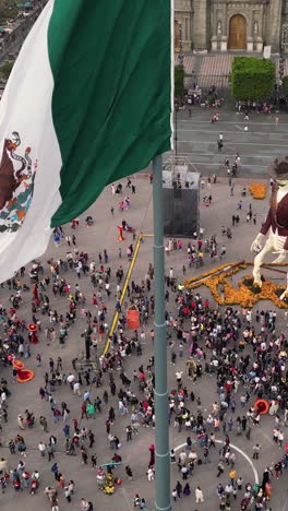 Monumental-flag-in-the-Zocalo-of-Mexico-City-on-Day-of-the-Dead,-vertical-aerial-view