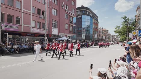 Spectators-clap-marching-soldiers-at-Bulgarian-Rose-Festival-street-parade