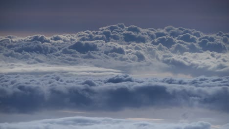 Wide-timelapse-of-fluffy-clouds-moving-in-distance,-seen-from-above