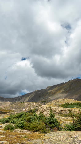 Vertical-4K-Timelapse,-Low-Clouds-Moving-Above-Sunny-Mountain-Landscape