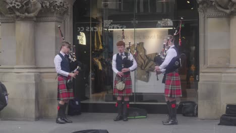 Musical-bagpipes-played,-city-centre,-street-entertainers,-slow-motion