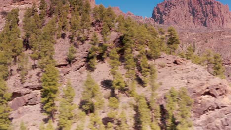 Aerial-Drone-tracking-across-ridge-towards-mountain-valley-in-Gran-Canaria-Spain