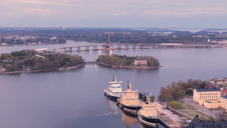 Drone-view-of-docked-icebreakers-fleet-and-Helsinki-Kruunuvuorensilta-bridge