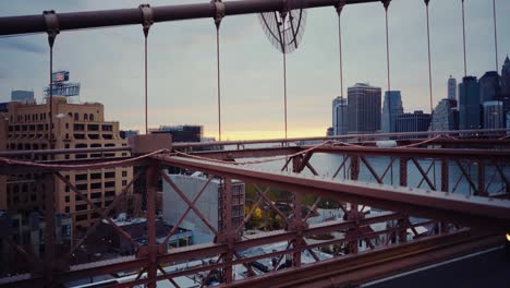 Brooklyn-Bridge-Pan-Right-To-Lower-Manhattan-Walkway-And-Roadway-Below-With-A-Beautiful-Sunset