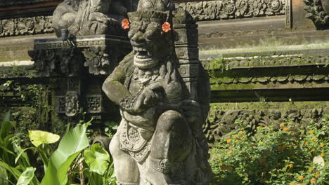 Details-of-Guardian-Stone-Statue-by-Royal-King-Pavilion-in-Ubud-Palace,-officially-Puri-Saren-Agung-in-Bali,-Indonesia---tilt-up