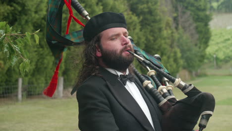 Male-Bagpipe-Player-Outdoors-Dressed-In-Formal-Suit