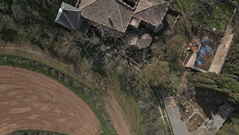 Reveal-shot-top-down-above-Perafita's-Castle-in-Catalonia,-Spain