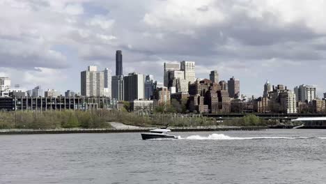 A-dynamic-scene-of-the-Brooklyn-waterfront-featuring-a-speeding-boat-against-a-backdrop-of-diverse-city-architecture-under-a-partly-cloudy-sky