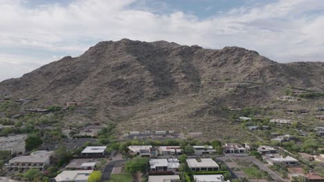 Aerial-shot-of-Mummy-Mountain,-Paradise-Valley-in-Arizona-with-cloudscape-at-background-in-USA