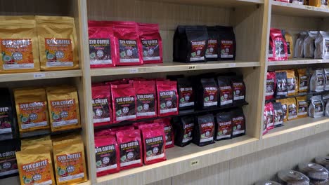 Flavoursome-drinks-packaged,-shop-wall-shelving,-roast-and-unroasted