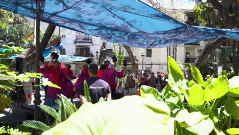 Elder-women-dance-show-in-Estepona-center-cafe,-slow-motion-view