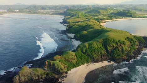 Drone-footage-:-Flying-over-of-breathtaking-landscape-of-rolling-hiils-surounded-by-beaches-on-bright-morning-in-Merese-hill,-Lombok-Island