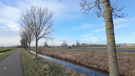 Bicycle-Lane-And-Dikes-Near-Road-Traffic-In-Netherlands