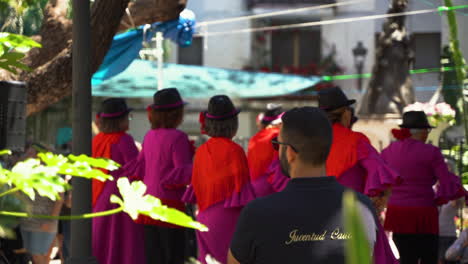 Group-of-elder-women-dancing-in-streets-of-Estepona,-Spain