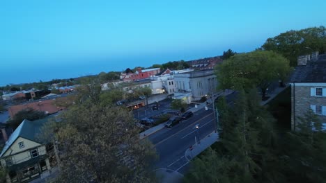 FPV-drone-shot-through-small-American-town-at-dusk