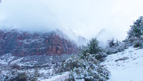 An-Ultra-Wide-shot-of-a-snow-covered-hiking-path-with-mountains-in-the-background-in-Zion-National-Park