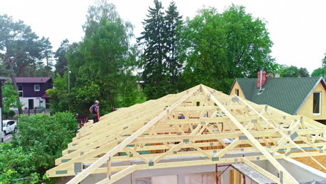 Home-Construction-With-Workers-On-Installation-Of-Timber-Trusses