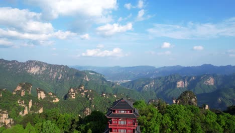 Aerial-pullback-shot-revealing-Tianzi-Pavilion-surrounded-by-lush-greenery-in-Zhangjiajie,-China