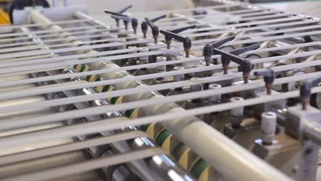 close-up-seen-Conveyor-roller-sorting-where-paper-is-being-made-and-appearing-in-different-rows