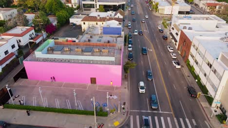 Aerial-Footage-of-Iconic-Pink-Wall-on-Melrose-Avenue-in-Los-Angeles,-Shopping-District-As-Seen-from-Above