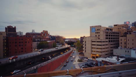 View-From-Brooklyn-Bridge-Looking-At-BQE-Expressway-With-Cars-And-A-Sunset