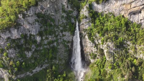 Static-aerial-shot-of-the-beautiful-Seerenbachfälle-waterfalls-and-their-rock-walls-mixed-with-greenery