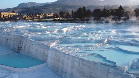 Steamy-blue-hot-springs,-mineral-water,-forming-travertine-limestone-mineral-deposit-formations