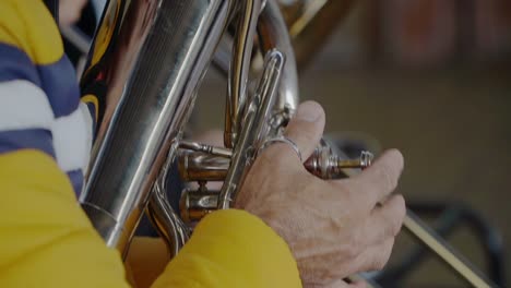 Closeup-of-a-hand-of-an-euphonium-player-pressing-the-valves