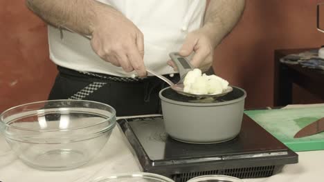 Kitchen-of-chef's-hands-taking-white-cauliflower-after-being-boiled-in-the-pot