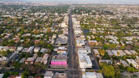 Birdseye-View-of-Melrose-Avenue-in-Los-Angeles,-California-on-Sunny-Bright-Afternoon,-Cars-Driving-Below