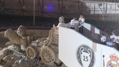 Dani-Carvajal,-Nacho-Fernandez,-Luka-Modric,-and-Toni-Kroos-raise-the-Champions-League-trophy-during-the-celebration-of-their-15th-Champions-League-title-at-Cibeles-Square-in-Madrid,-Spain