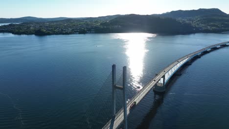 Iconic-floating-Nordhordland-bridge,-summer-day-aerial-view-with-reflections-in-fjord