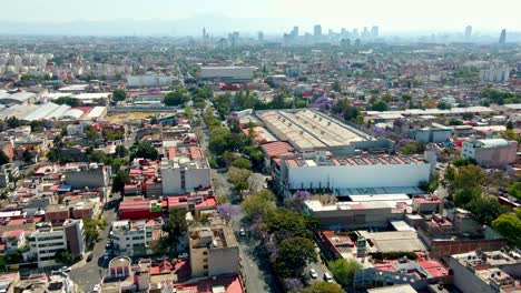 Bird's-eye-view-establishing-in-the-industrial-neighborhood-in-Mexico-City-on-a-sunny-day,-low-architecture,-residential-area