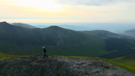 Mountain-walker-stepping-up-to-summit