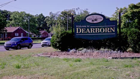 Welcome-to-Dearborn-sign-with-traffic-driving-by-an-stable-wide-shot-video