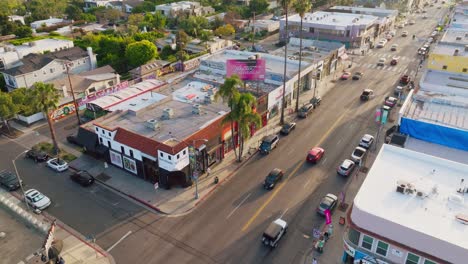 A-Beautiful-Day-in-the-Neighborhood,-Aerial-Drone-Shot-of-Busy-West-Hollywood-Melrose-Area-in-Sunny-Daytime-Light,-Lots-of-Cars-and-Pedestrians-in-Iconic-Shopping-District