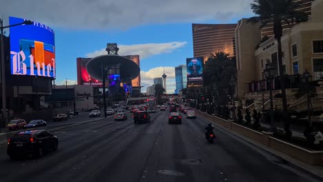 Evening-Traffic-on-Las-Vegas-Strip,-Driver's-POV-of-Cars-and-Buildings,-Passing-Wynn,-Encore-and-Fashion-Show-Mall